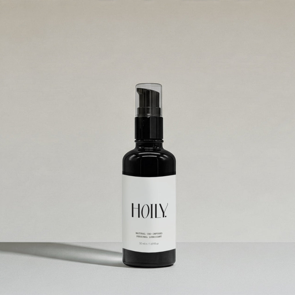 Black HOILY Natural CBD personal lubricant spray bottle on a light grey background