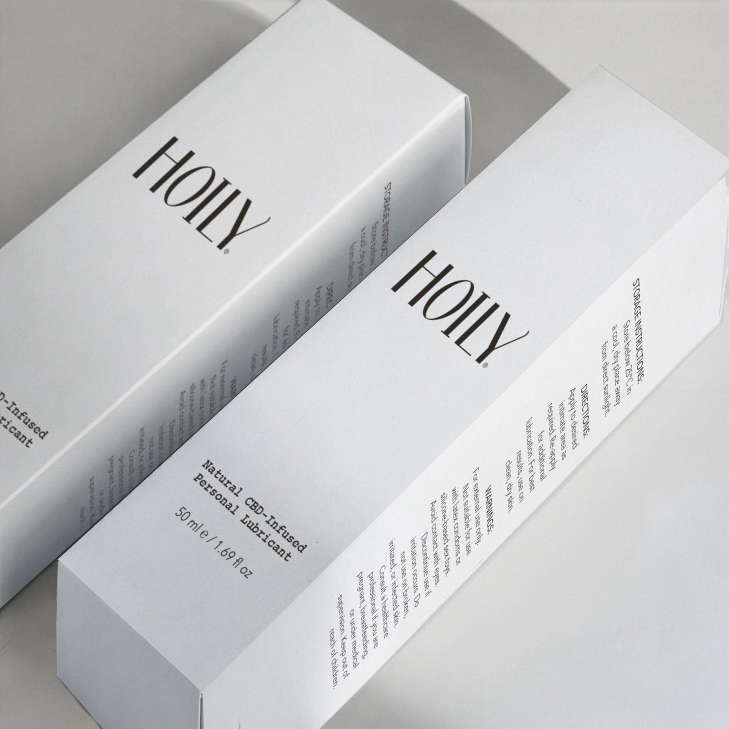 Two boxes of Hoily on a light gray background